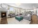 Cozy living room with a fireplace, plush seating, and an open layout connecting to the kitchen, ideal for gatherings at 2679 Leafdale Cir, Castle Rock, CO 80109