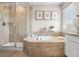 This main bathroom features a glass-enclosed shower, soaking tub, and tile surround at 2679 Leafdale Cir, Castle Rock, CO 80109