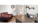 Office featuring hardwood floors, a wooden desk, a leather chair and french doors that lead to another room at 2679 Leafdale Cir, Castle Rock, CO 80109