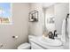 Well-lit powder room featuring a white vanity, stylish fixtures, and a decorative shelf adding a touch of modern elegance at 2679 Leafdale Cir, Castle Rock, CO 80109