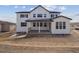 Rear exterior showcasing a two-story white home with a covered porch at 4741 Twelve Oaks Way, Castle Rock, CO 80104