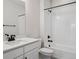 Bathroom features a shower and tub, white tiled wall and vanity with a black faucet at 4741 Twelve Oaks Way, Castle Rock, CO 80104