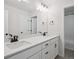 Bright bathroom featuring a double vanity with black hardware and large mirror at 4741 Twelve Oaks Way, Castle Rock, CO 80104