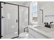 Bright bathroom with glass shower, tile surround, black hardware, and quartz counters at 4741 Twelve Oaks Way, Castle Rock, CO 80104