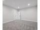 Spacious bedroom with neutral carpeting and multiple white doors, offering versatility and ample storage options at 4741 Twelve Oaks Way, Castle Rock, CO 80104