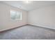 Cozy bedroom with a large window, neutral walls, and soft carpeting at 4741 Twelve Oaks Way, Castle Rock, CO 80104