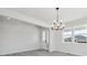 Bright dining area with laminate flooring, modern chandelier, and a view to the exterior at 4741 Twelve Oaks Way, Castle Rock, CO 80104