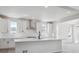 Bright kitchen featuring white cabinets, stainless steel hood, quartz counters, and large island at 4741 Twelve Oaks Way, Castle Rock, CO 80104