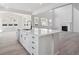 Bright kitchen with white cabinets, quartz counters, an island with seating, and stainless appliances at 4741 Twelve Oaks Way, Castle Rock, CO 80104