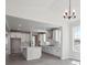 Contemporary kitchen features an island, white cabinets, stainless steel appliances, and modern pendant lighting at 4741 Twelve Oaks Way, Castle Rock, CO 80104