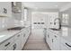 Modern kitchen with white cabinets, quartz countertops, an island, and a view into the dining area at 4741 Twelve Oaks Way, Castle Rock, CO 80104