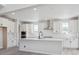 Modern kitchen with white cabinets, stainless steel appliances, and a central island at 4741 Twelve Oaks Way, Castle Rock, CO 80104