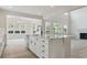 Open-concept kitchen featuring white cabinets, a large island, and stainless appliances at 4741 Twelve Oaks Way, Castle Rock, CO 80104