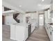 Bright kitchen features a large island with a black faucet, stainless steel appliances, and wooden floors at 4741 Twelve Oaks Way, Castle Rock, CO 80104
