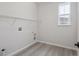 A utility room featuring connections for a washer and dryer, wire shelving, and wood-look floors at 4741 Twelve Oaks Way, Castle Rock, CO 80104