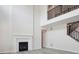 Bright living room with tall ceilings, fireplace, and laminate flooring with staircase to upper level at 4741 Twelve Oaks Way, Castle Rock, CO 80104