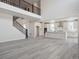 Open-concept living space with a staircase and seamless flow to a bright, modern kitchen at 4741 Twelve Oaks Way, Castle Rock, CO 80104