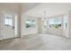 Bright living room featuring expansive windows and light wood-look floors at 4741 Twelve Oaks Way, Castle Rock, CO 80104