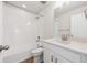 Well-lit bathroom featuring white vanity, quartz countertop, white cabinetry, tub and shower combo and wood look floor at 841 Alpine Ridge St, Erie, CO 80516