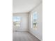 Bright bedroom featuring neutral carpet, white walls, and natural light from two windows at 841 Alpine Ridge St, Erie, CO 80516