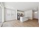 Open-concept living space with kitchen, stainless appliances, island, and access to patio via sliding glass doors at 841 Alpine Ridge St, Erie, CO 80516