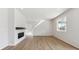 Open-concept living space with sleek fireplace, hardwood floors, and light-filled interior at 841 Alpine Ridge St, Erie, CO 80516