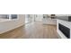 Open-concept living space with hardwood floors, fireplace, kitchen with stainless appliances, and sliding doors to patio at 841 Alpine Ridge St, Erie, CO 80516
