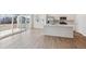 Open-concept space with kitchen, stainless appliances, island, and floor-to-ceiling sliding glass doors to patio at 841 Alpine Ridge St, Erie, CO 80516