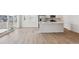 Bright open-concept space with access to patio, flowing from kitchen, which features stainless appliances and white island at 841 Alpine Ridge St, Erie, CO 80516