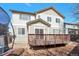 Backyard with wood deck and view of the home's exterior at 21286 E Nassau Ave, Aurora, CO 80013