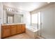 This bathroom features a double sink vanity and a separate tub and shower at 21286 E Nassau Ave, Aurora, CO 80013