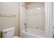 Bright bathroom area showcasing tiled shower/tub and toilet at 21286 E Nassau Ave, Aurora, CO 80013
