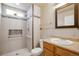 This bathroom features stylish tile accents, a walk-in shower, and a modern vanity at 21286 E Nassau Ave, Aurora, CO 80013