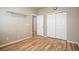 Bedroom with wood floors, closet, and convenient access to other rooms at 21286 E Nassau Ave, Aurora, CO 80013