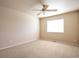 Bright bedroom features a ceiling fan and a window providing natural light at 21286 E Nassau Ave, Aurora, CO 80013