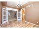 Dining room featuring hardwood floors and an elegant chandelier, open to the entryway and kitchen at 21286 E Nassau Ave, Aurora, CO 80013