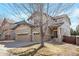 Attractive two-story home featuring a three-car garage, and neutral tones, surrounded by mature landscaping at 21286 E Nassau Ave, Aurora, CO 80013
