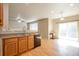 Kitchen with wood cabinets and granite countertops open to breakfast nook with sliding door to patio at 21286 E Nassau Ave, Aurora, CO 80013