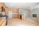 Modern kitchen featuring wood cabinets, granite counters, stainless appliances, that connects to the living space at 21286 E Nassau Ave, Aurora, CO 80013