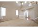 Spacious living area boasts high ceilings, and abundant natural light from large windows at 21286 E Nassau Ave, Aurora, CO 80013