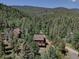 Aerial view of a home surrounded by trees and mountains at 10438 Sunlight Ln, Conifer, CO 80433
