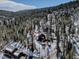 An aerial view of the home nestled among the trees at 10438 Sunlight Ln, Conifer, CO 80433