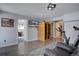 Finished basement with a tv, sauna, exercise bike, and exterior walkout to patio at 10438 Sunlight Ln, Conifer, CO 80433