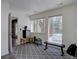 Finished basement area with workout equipment, a mini fridge and double door access to the outside at 10438 Sunlight Ln, Conifer, CO 80433