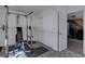 Basement workout area with exercise equipment, sliding door closet, and access to another room at 10438 Sunlight Ln, Conifer, CO 80433