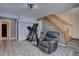 A basement with a treadmill, bike, and leather recliner for relaxation after exercising at 10438 Sunlight Ln, Conifer, CO 80433