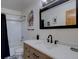 Bright bathroom with white subway tile, modern vanity with a beautiful mirror and decorative black and white floors at 10438 Sunlight Ln, Conifer, CO 80433