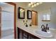 Bathroom featuring a double sink vanity with tile countertop, and access to the shower and toilet area at 10438 Sunlight Ln, Conifer, CO 80433