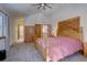 Vaulted ceiling bedroom with carpeted floor, wood furniture, and a view to the bathroom and stairway at 10438 Sunlight Ln, Conifer, CO 80433