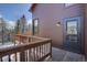 View of the home's wood deck with railings and stairs plus mountain views at 10438 Sunlight Ln, Conifer, CO 80433